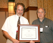 Philip Sadler receives the 2012 Millikan Medal from AAPT President David Sokoloff.