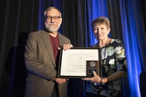 Stephen Pompea is presented with the Millikan Medal by Mary Mogge, Chair of the AAPT Awards Committee.
